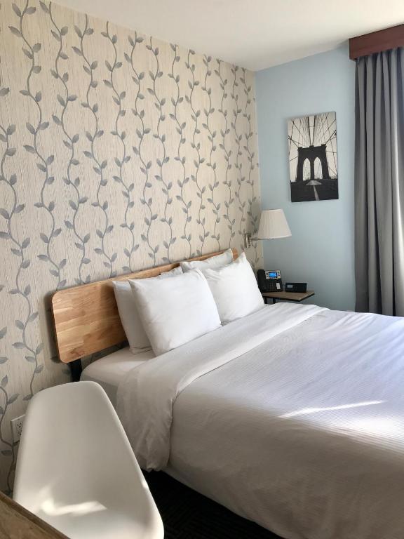 Posteľ alebo postele v izbe v ubytovaní Hotel Mimosa