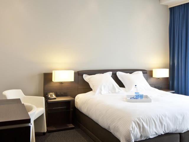 Postel nebo postele na pokoji v ubytování Blue Woods Hotel - Deerlijk