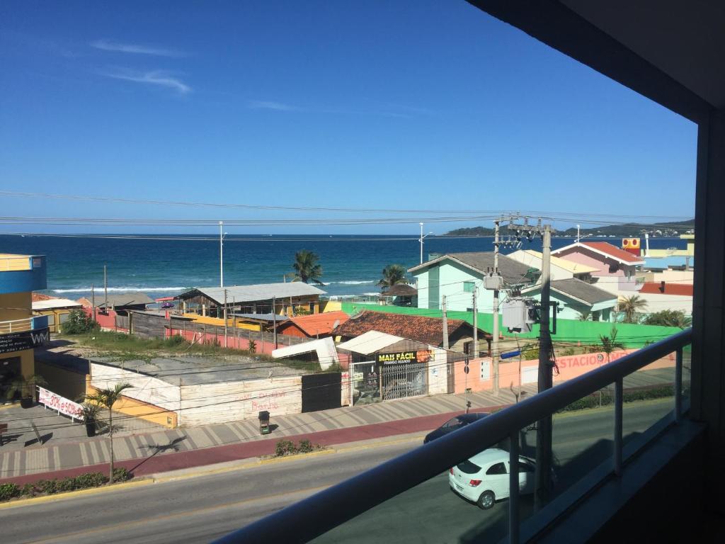 a view of the ocean from a balcony at Apartamentos Mediterrâneo Home Club in Bombinhas
