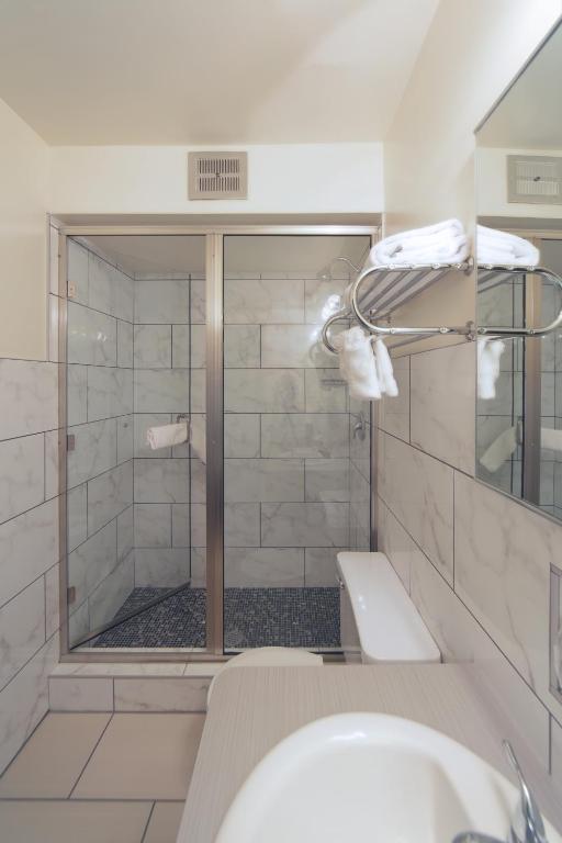 a bathroom with a shower and a sink at Hotel Ruby in Spokane
