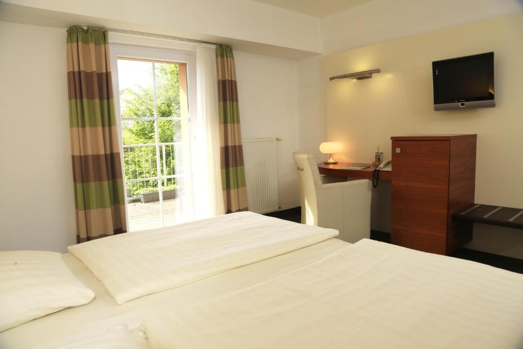 Postel nebo postele na pokoji v ubytování Landidyll Hotel Klostermühle