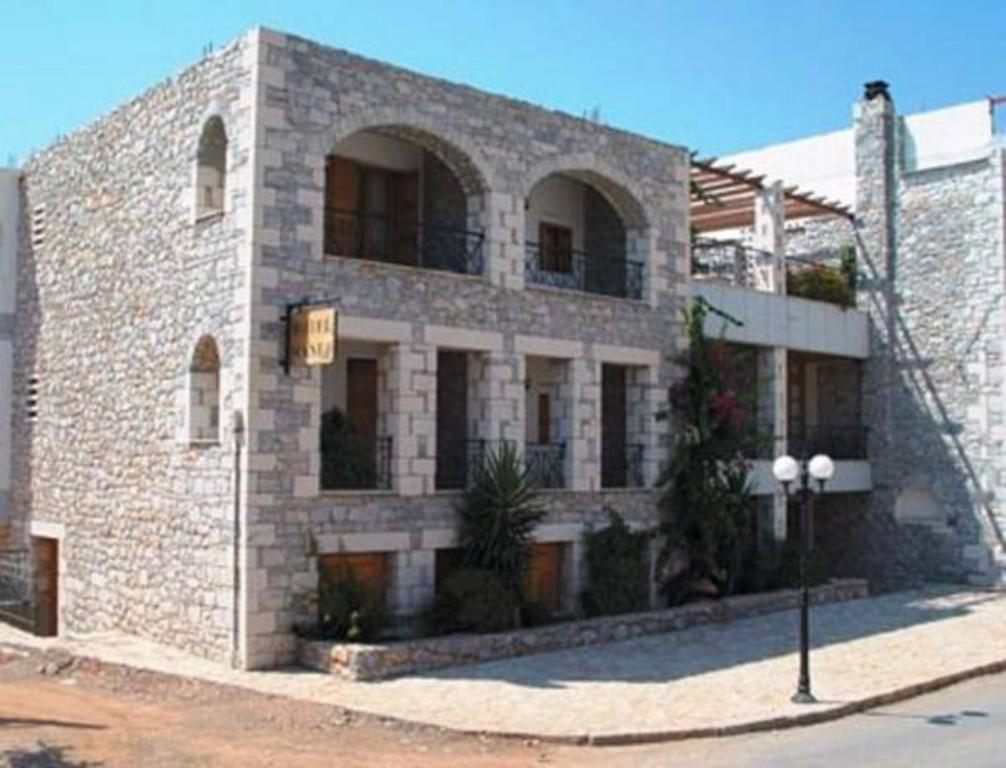 a large brick building with windows on a street at Mani Hotel in Areopoli