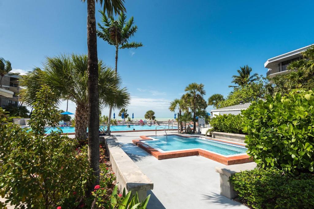a pool at a resort with palm trees at Coconut Palms in Key West