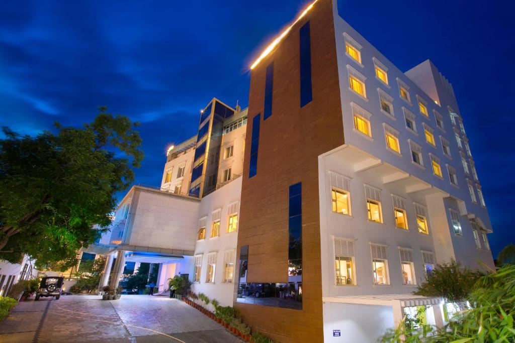 a building with yellow lights on the side of it at Hotel Atithi in Pondicherry