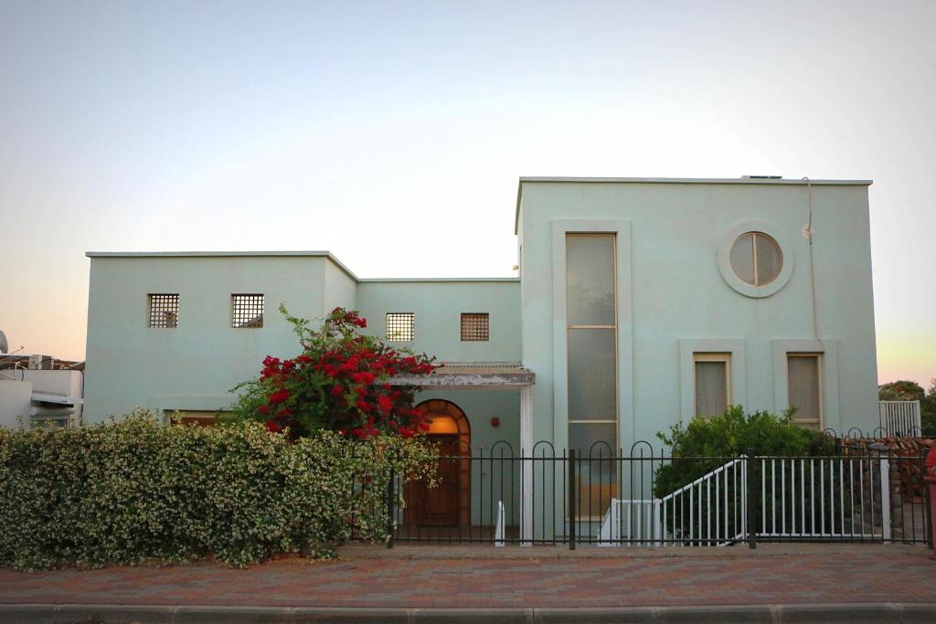 a white house with a fence in front of it at Aviv Beautiful Villa, 5 BR, Golan Heights in Giv'at Yo'av