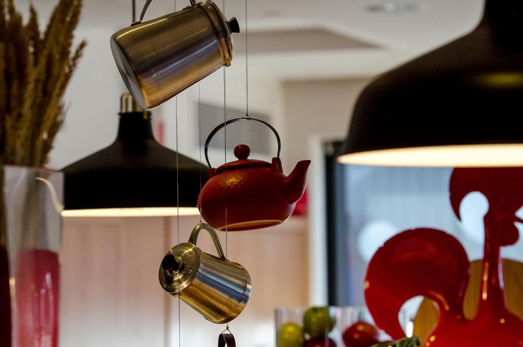 a tea kettle hanging from a light fixture at Hotel Ibis Lisboa Sintra in Sintra