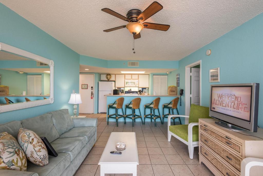 a living room with a couch and a tv at Sunrise Suites Cozumel Suite #112 in Key West