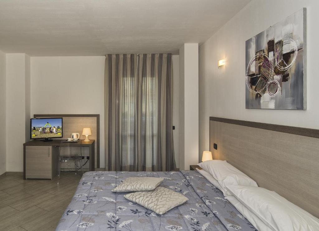 Postel nebo postele na pokoji v ubytování Hotel Lido Inn