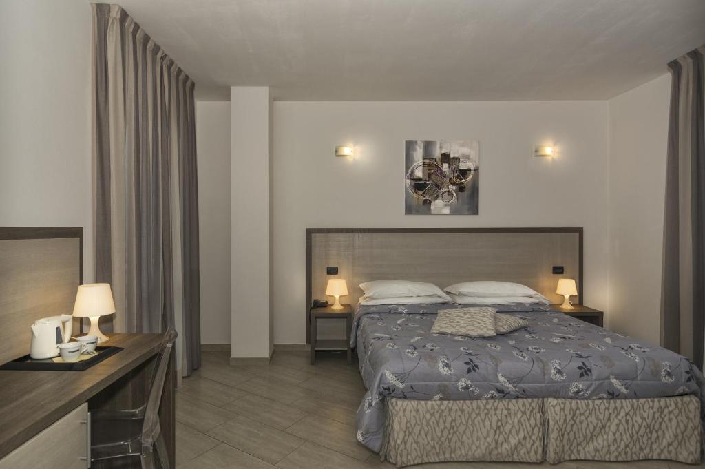 Postel nebo postele na pokoji v ubytování Hotel Lido Inn