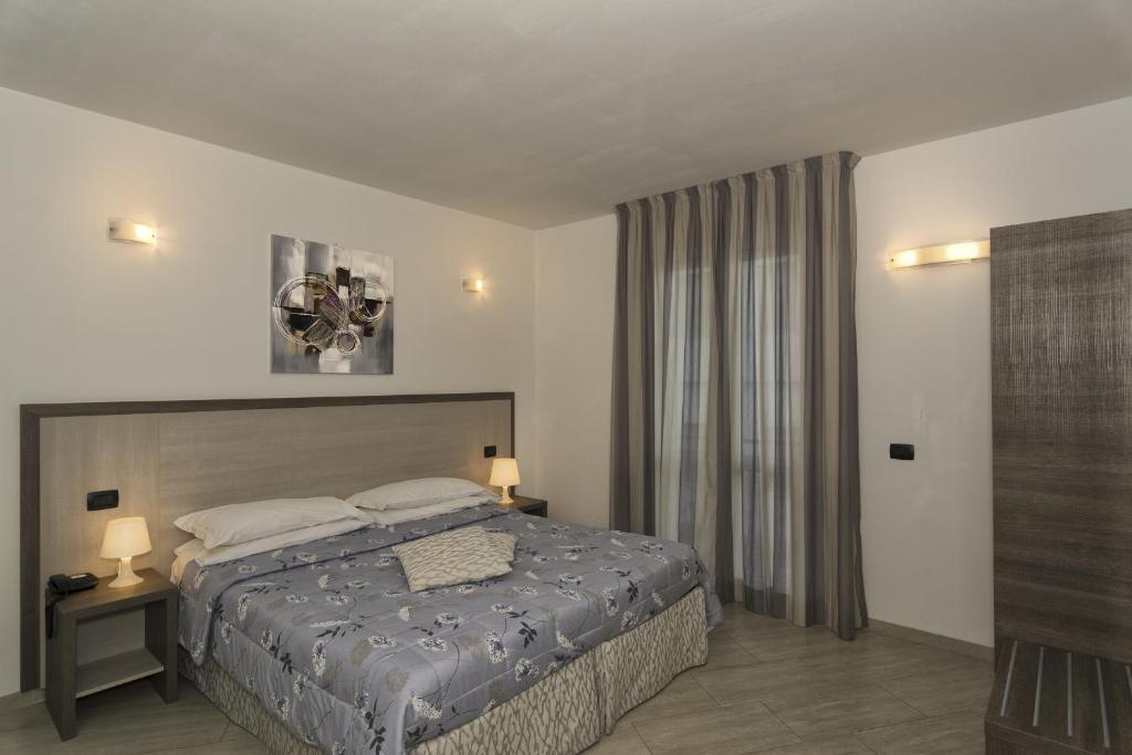 Postel nebo postele na pokoji v ubytování Hotel Lido Inn