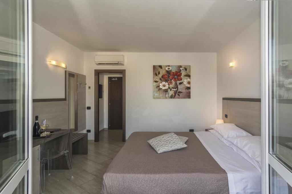 Postel nebo postele na pokoji v ubytování Hotel Lido Inn
