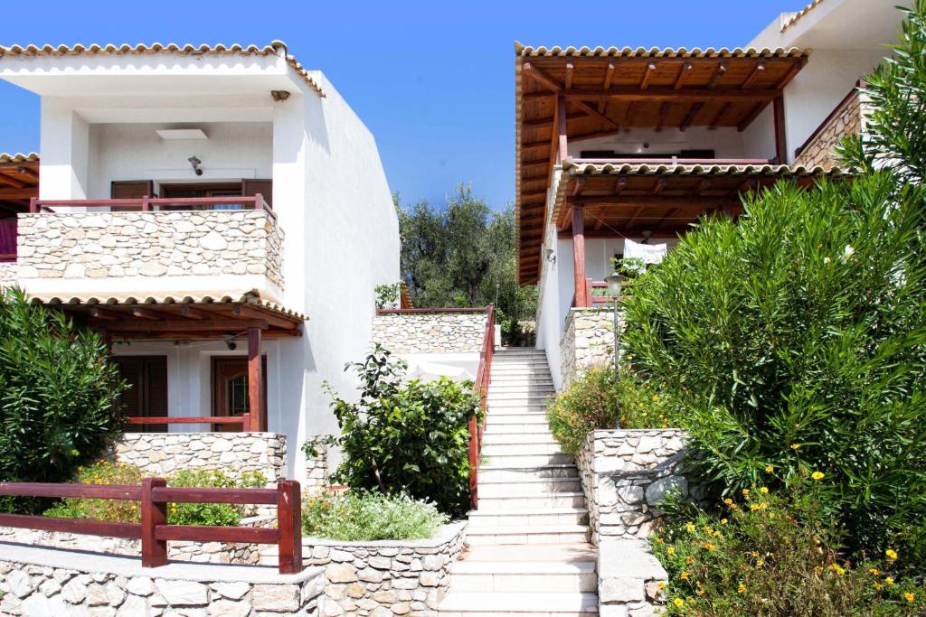 a stairway leading up to a white house at Villa Maraki in Agia Paraskevi