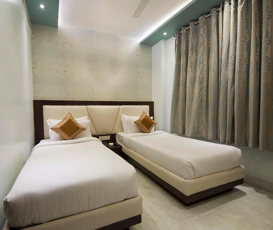 Postel nebo postele na pokoji v ubytování Hotel Central Residency