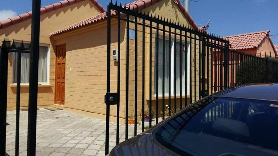a black fence in front of a house at Santa Margarita Coquimbo in Coquimbo