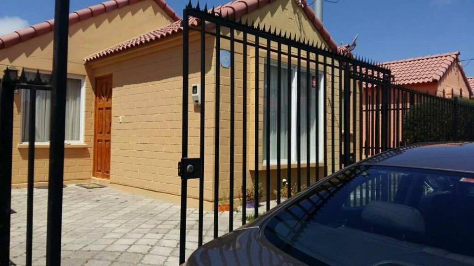 a black fence in front of a house at Santa Margarita Coquimbo in Coquimbo