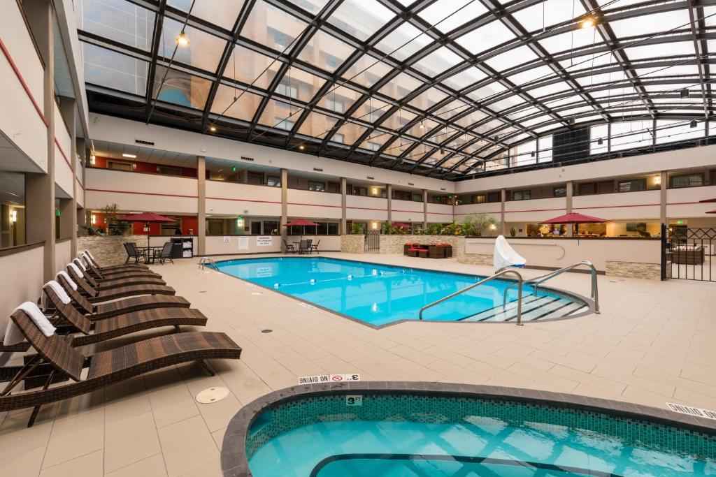a large swimming pool with a glass ceiling at Holiday Inn Brookfield - Milwaukee, an IHG Hotel in Brookfield