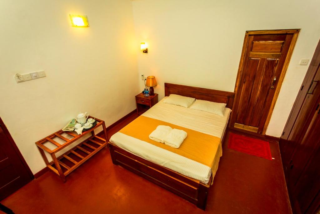Postel nebo postele na pokoji v ubytování Dayanithi Guest House