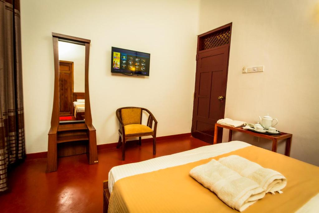 Postel nebo postele na pokoji v ubytování Dayanithi Guest House