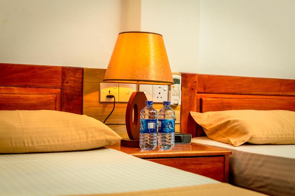 Postel nebo postele na pokoji v ubytování Dayanithi Guest House