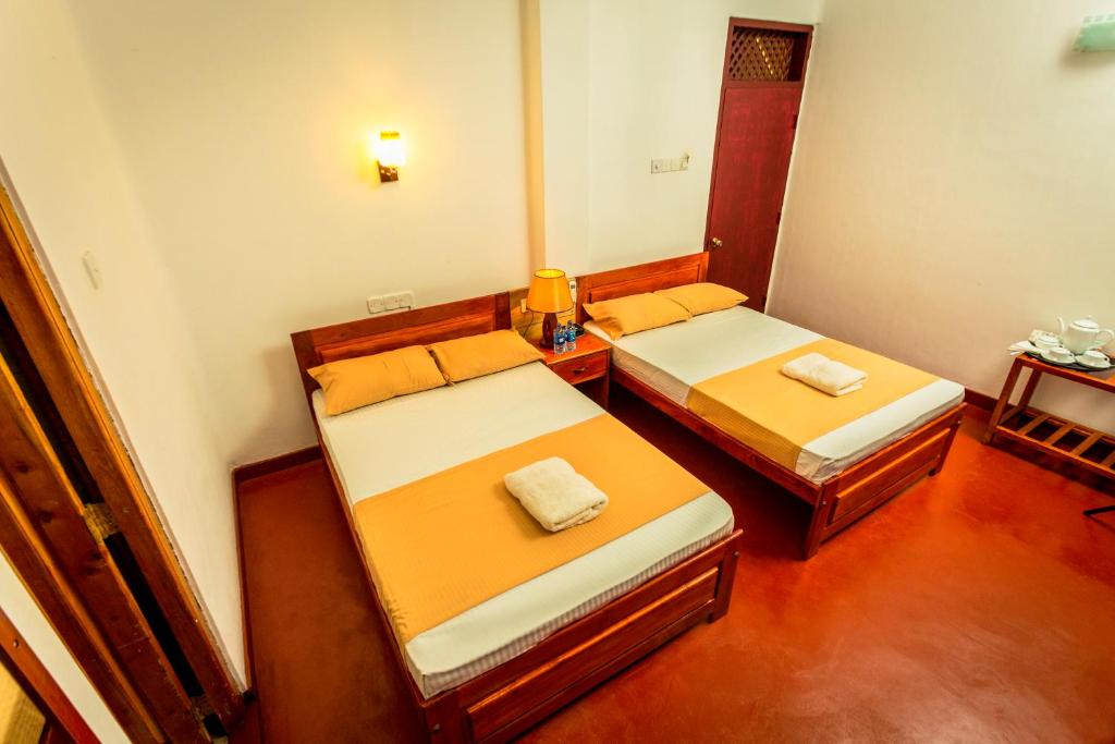 Postel nebo postele na pokoji v ubytování Dayanithi Guest House