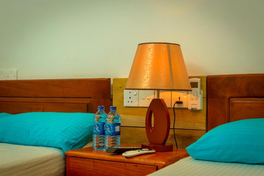 Postel nebo postele na pokoji v ubytování Dayanithi Guest House
