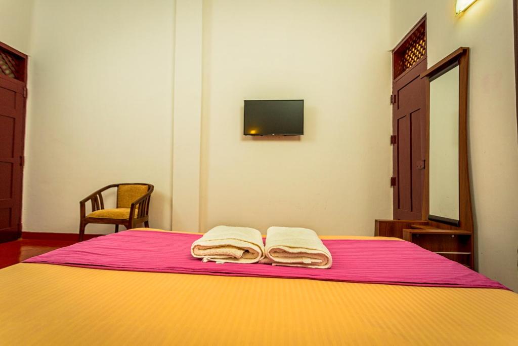 Postel nebo postele na pokoji v ubytování Dayanithi Guest House