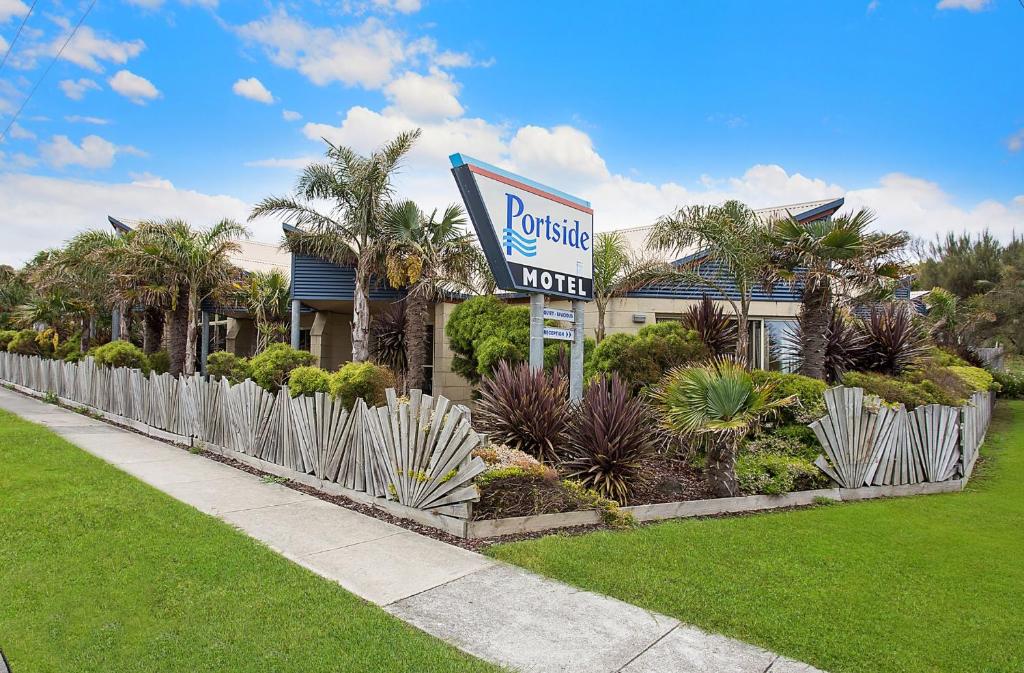 a garden area with palm trees and palm trees at Portside Motel in Port Campbell