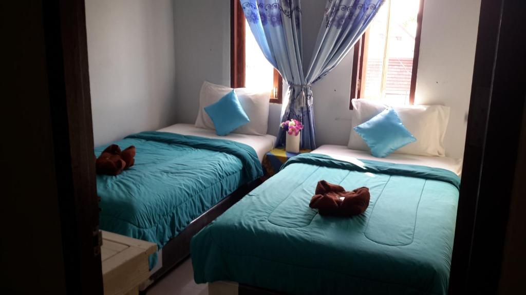 Postel nebo postele na pokoji v ubytování Kohkaew Village 2@Kohsamet