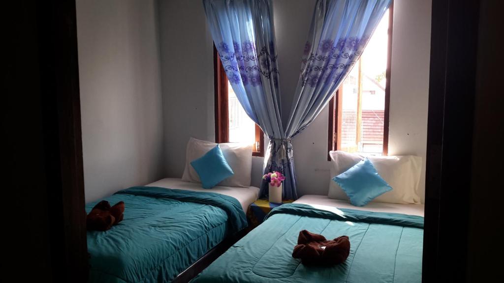 Postel nebo postele na pokoji v ubytování Kohkaew Village 2@Kohsamet