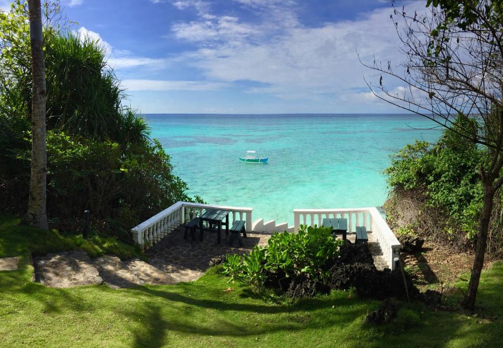 a view of the ocean with a boat in the water at Casa Amihan in Anda