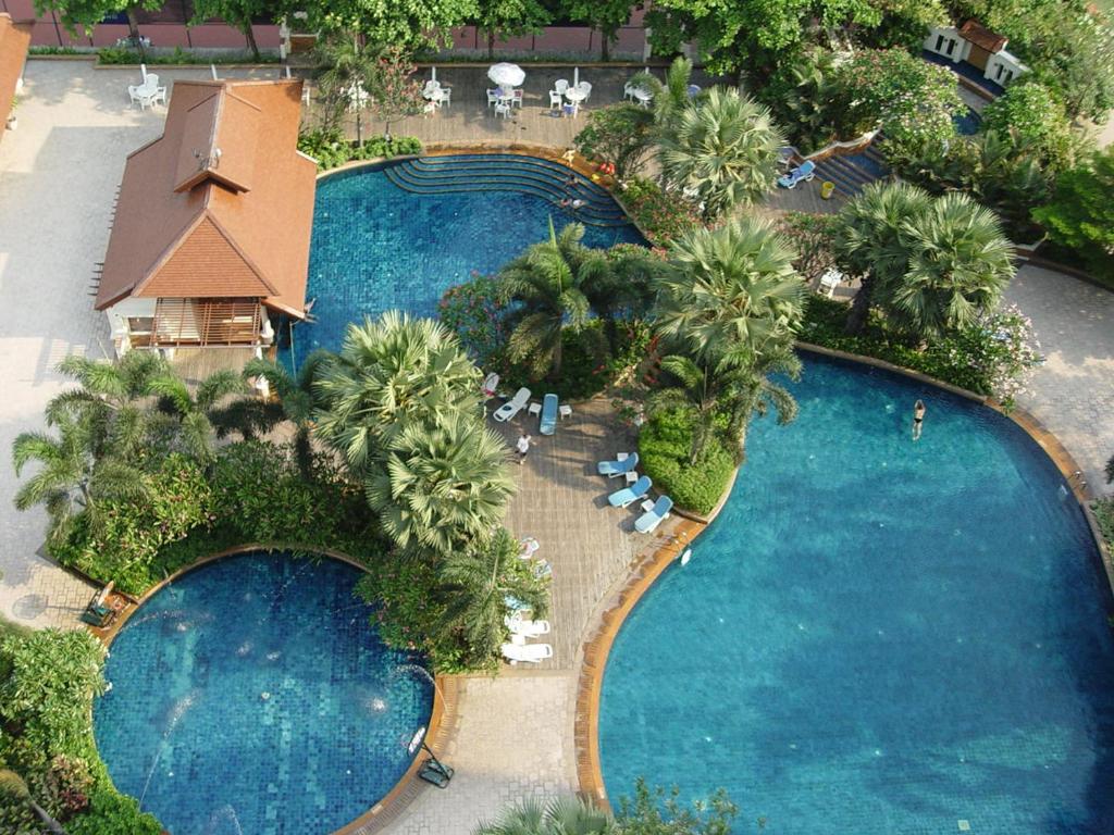 An aerial view of a large landscaped pool complex with several connected pools.