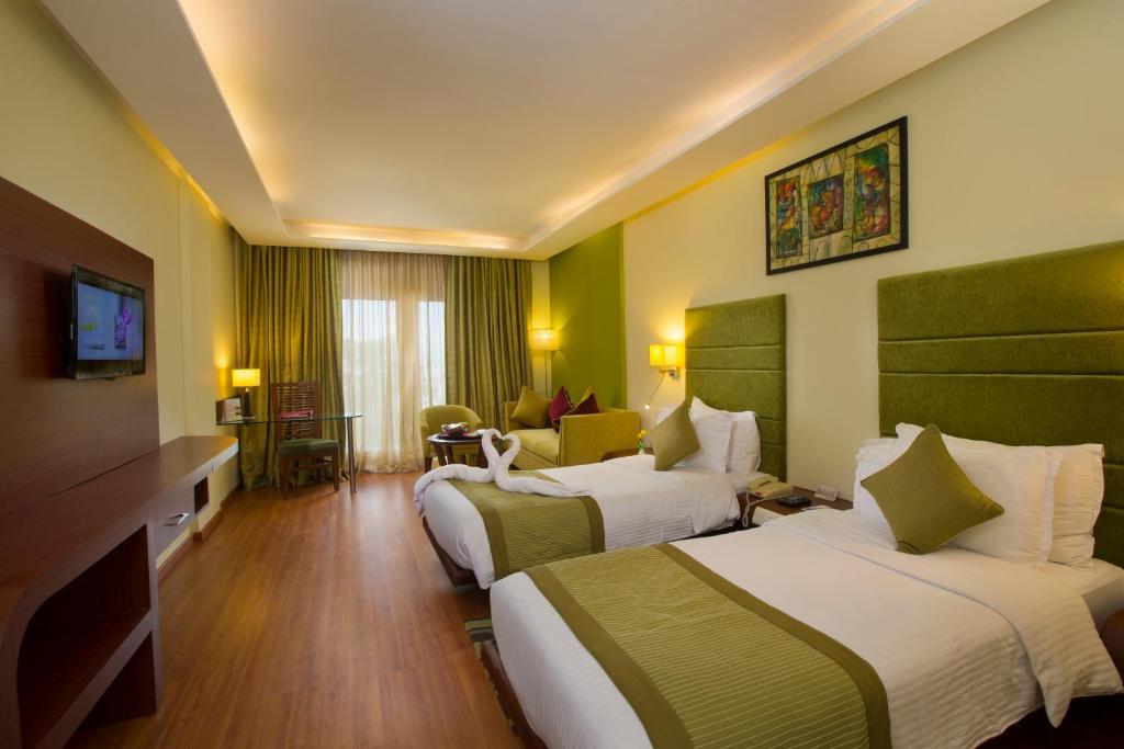 Postel nebo postele na pokoji v ubytování Hotel Atithi