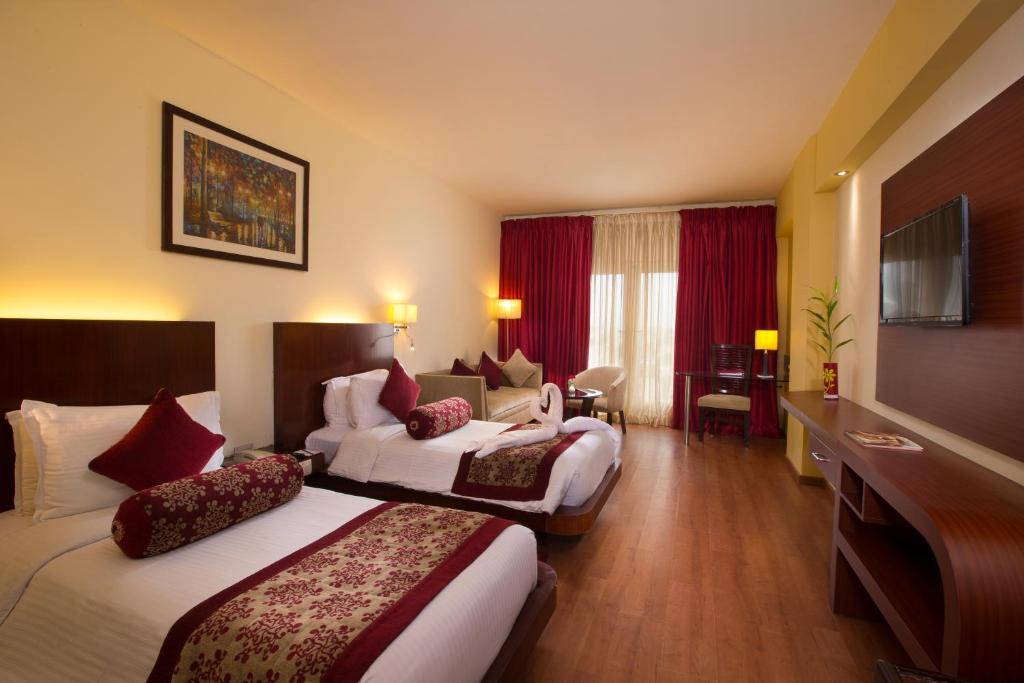 Postel nebo postele na pokoji v ubytování Hotel Atithi