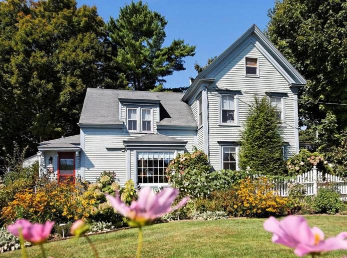 una casa con flores rosas delante de ella en Black Lantern B&B en Topsham