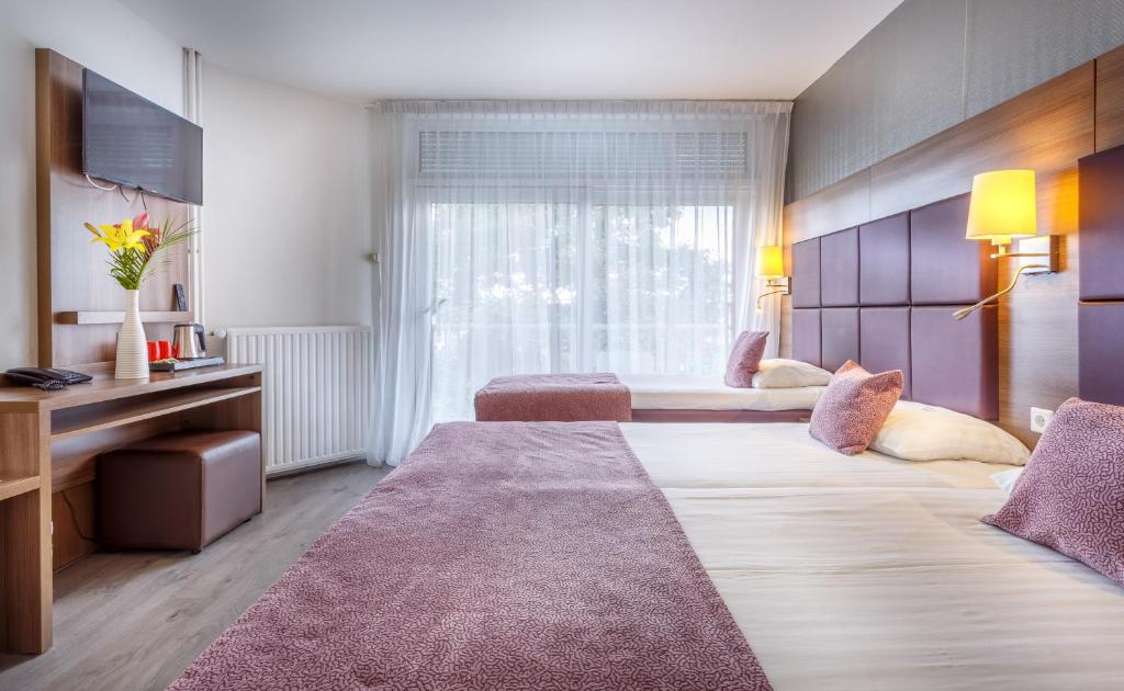 Postel nebo postele na pokoji v ubytování Hotel Victorie