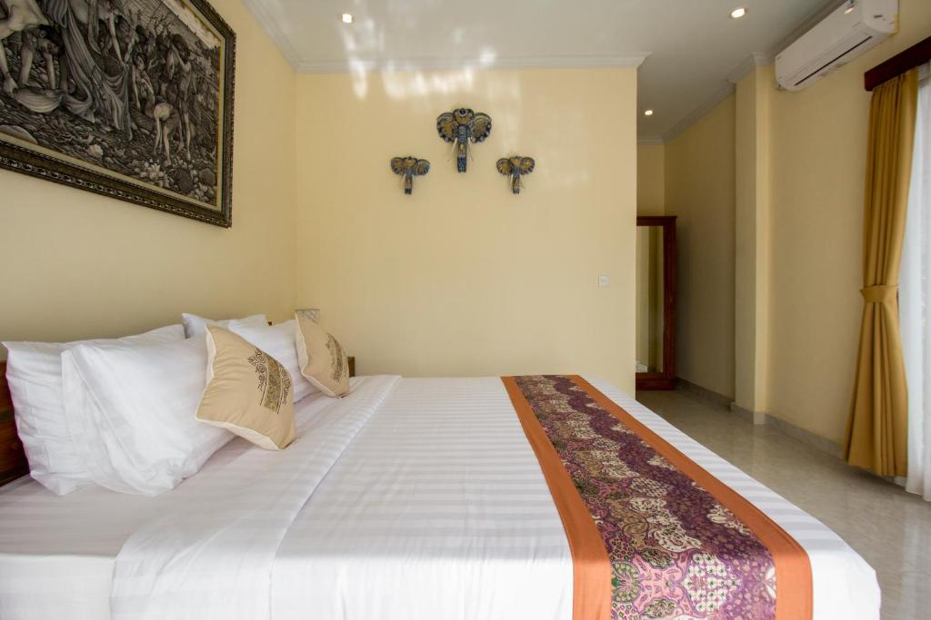 Postel nebo postele na pokoji v ubytování Yudha Ubud