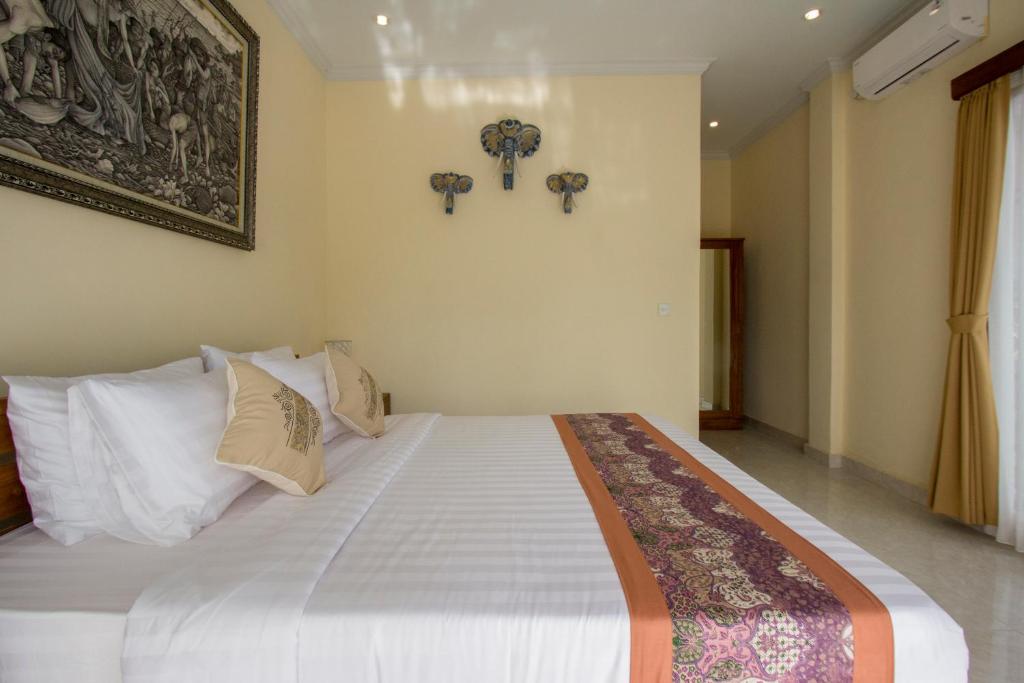 Postel nebo postele na pokoji v ubytování Yudha Ubud