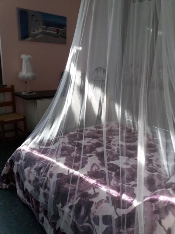a bedroom with a bed with a mosquito net at B&B da Jordan in Gorgonzola