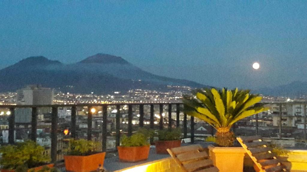 a balcony with a view of a city at night at A wonderful penthouse in Naples in Naples