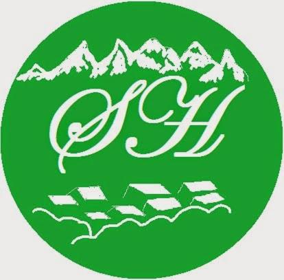 a green logo with a mountain on it at Shrestha Hotel & Restaurant in Bandipur