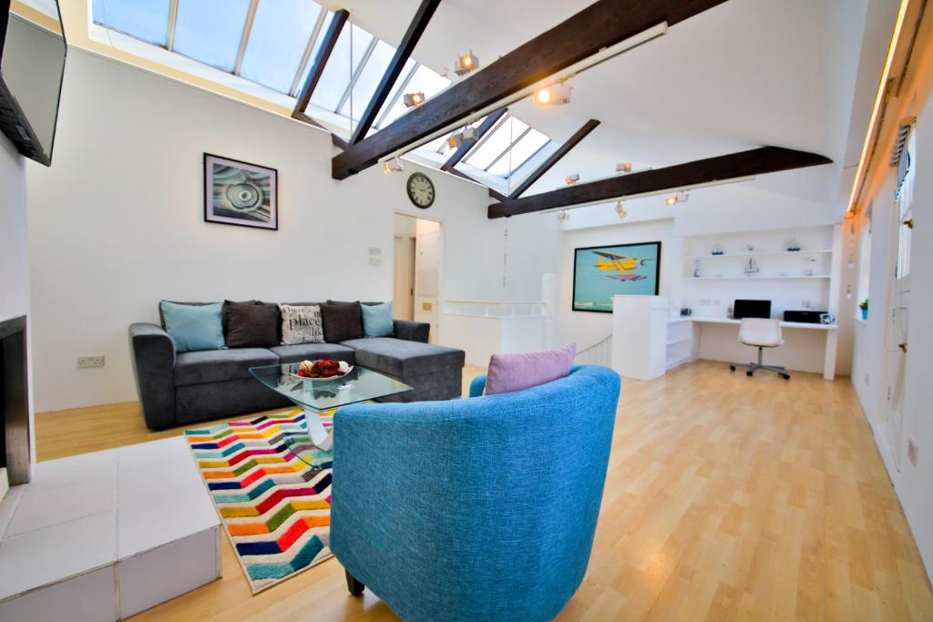 a living room with a couch and a table at Sussex Mews House in Brighton & Hove