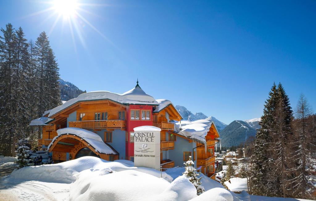 
a snow covered building with a snowmobile on top of it at Cristal Palace Hotel in Madonna di Campiglio

