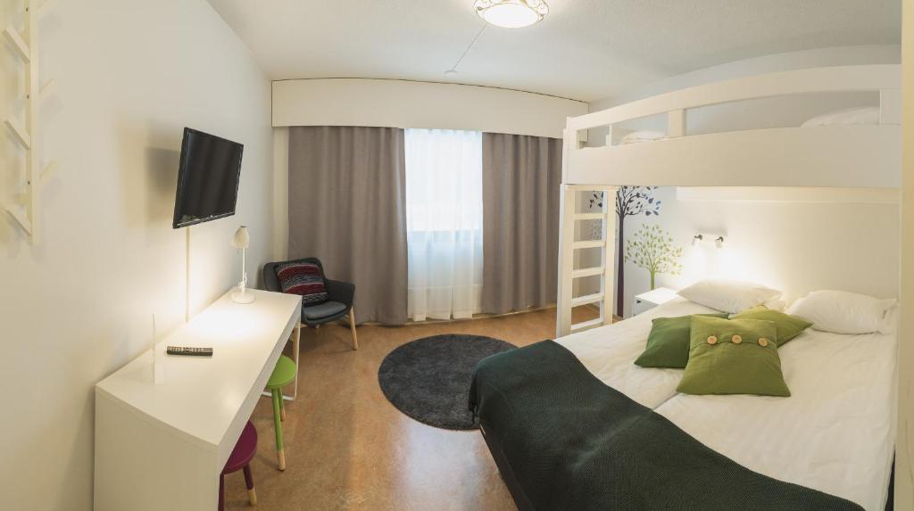 Postel nebo postele na pokoji v ubytování Hotel Kittilä
