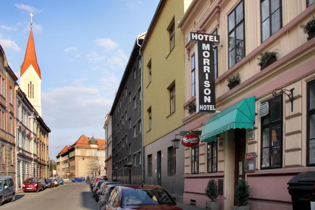 a street with cars parked on the side of a building at Penzion Hotel Morrison in Plzeň