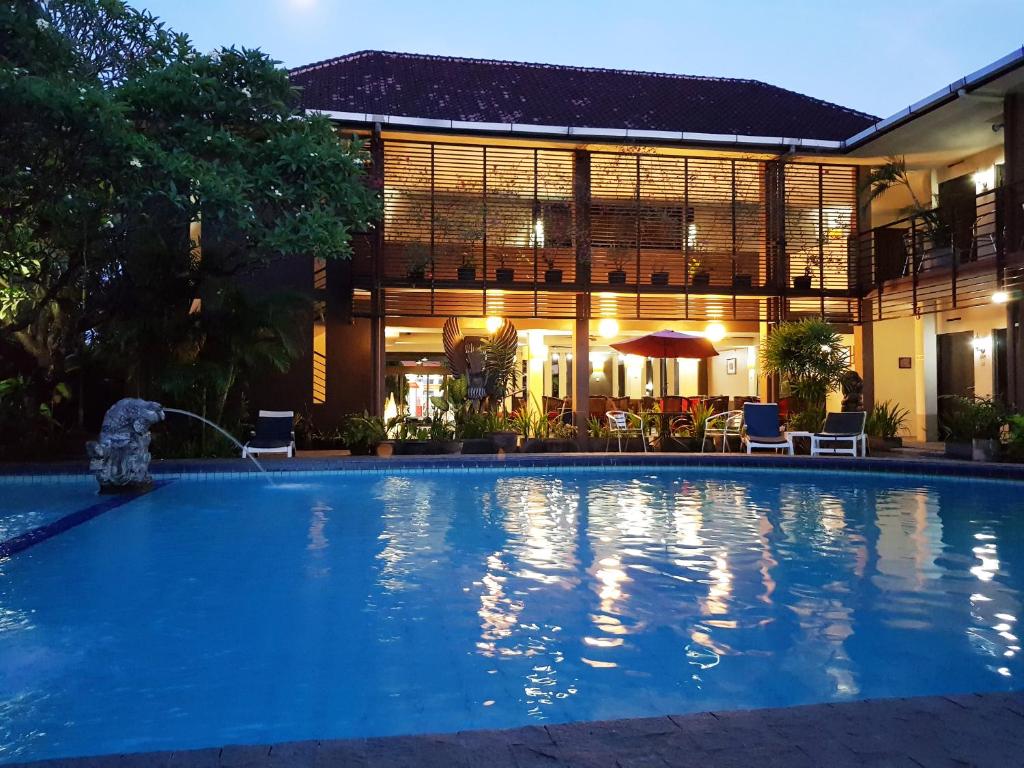 a large swimming pool in front of a building at Sanur Agung Hotel in Sanur