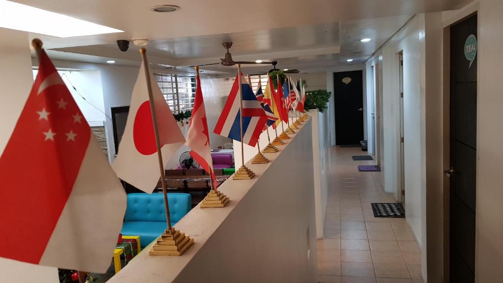 a row of flags are lined up in a hallway at Crossroads Hostel Manila in Manila