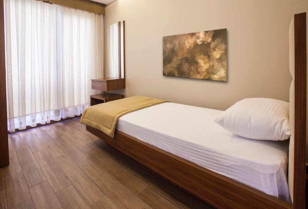 Postel nebo postele na pokoji v ubytování Maxuite Hotel in Home