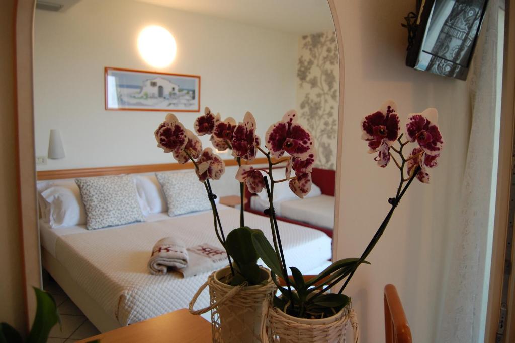 Postel nebo postele na pokoji v ubytování Hotel Rivazzurra