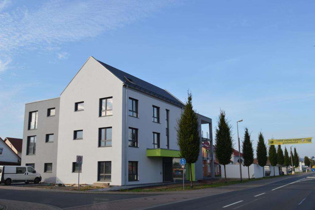 a white building on the side of a street at Boardinghouse-Niedernberg in Niedernberg