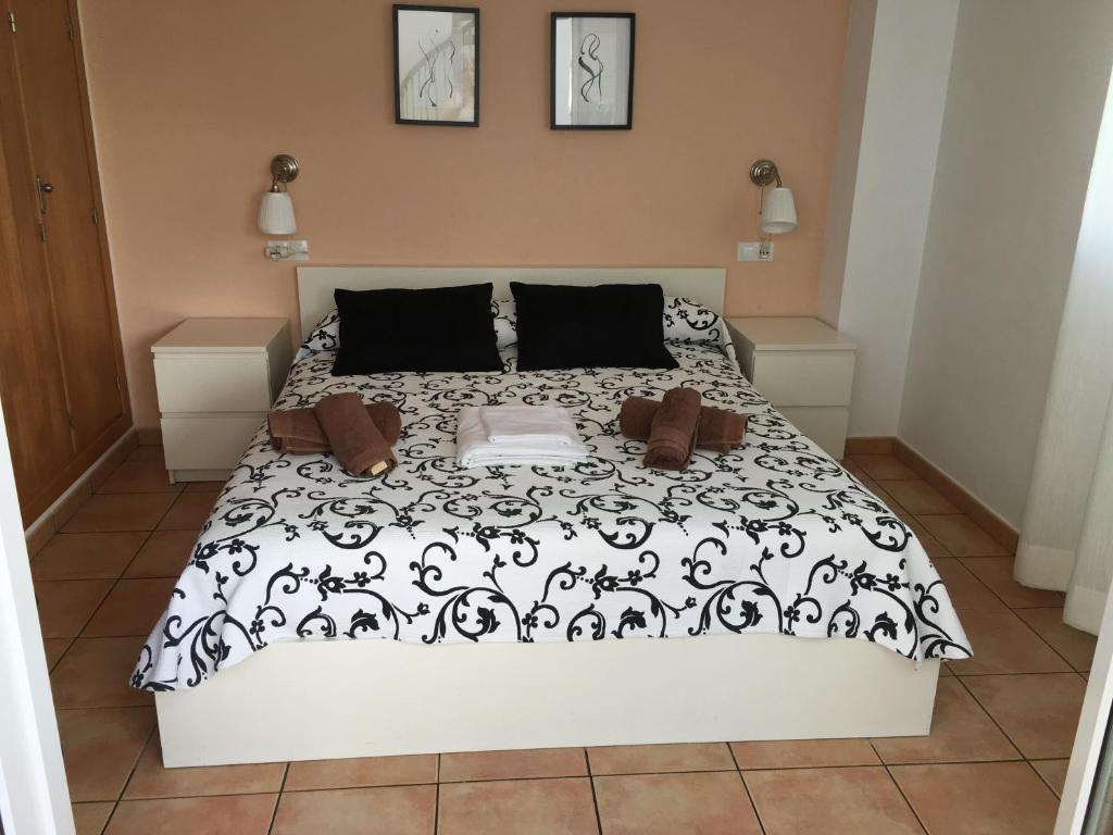 コニル・デ・ラ・フロンテーラにあるApartamento Mirador de Castilnovoのベッドルーム1室(ベッド1台、白黒の掛け布団付)